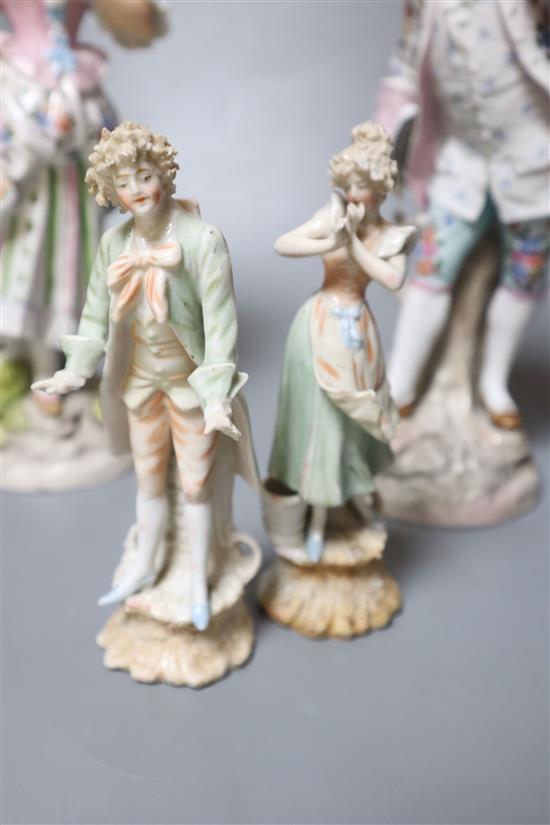 Two pairs of Continental porcelain figures of a man and woman, 15cm and 26cm